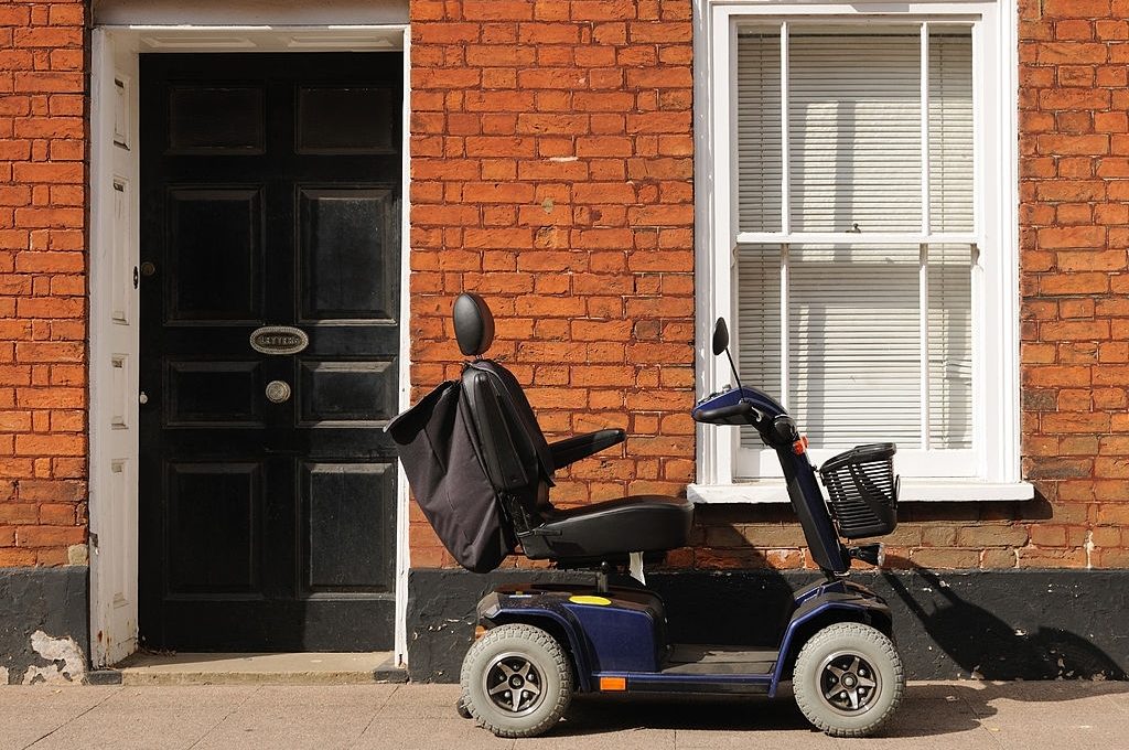 "Mobility scooter parked outside a house in a Suffolk town, England."