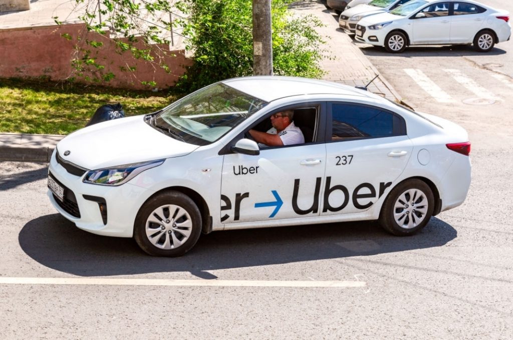 Samara, Russia - June 8, 2019: Uber taxi goes down the street in the afternoon. Modern city taxi